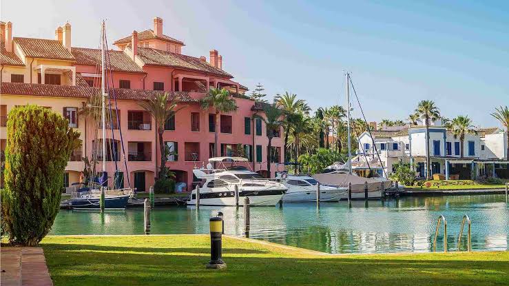 Boats moored along the waterfront homes of Sotogrande marina